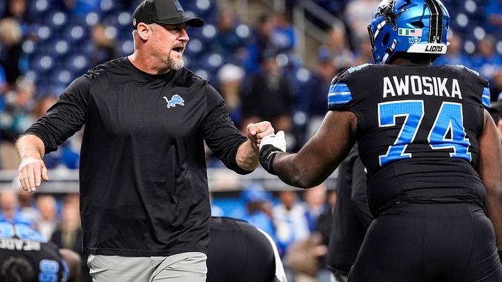 Detroit Lions head coach Dan Campbell fist bumps guard Kayode Awosika (74) during warmup ahead of the New York Giants game at Ford Field in Detroit on Sunday, Nov. 23, 2025. Detroit Lions head coach Dan Campbell fist bumps guard Kayode Awosika (74) during warmup ahead of the New York Giants game at Ford Field in Detroit on Sunday, Nov. 23, 2025.