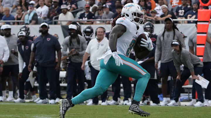 Aug 10, 2025; Chicago, Illinois, USA; Miami Dolphins running back Alexander Mattison (8) runs the ball against the Chicago Bears during the second half at Soldier Field. Mandatory Credit: David Banks-Imagn Images