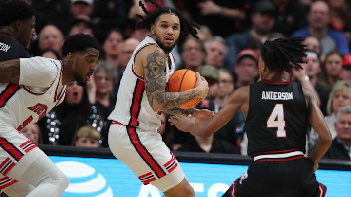 Houston guard Emanuel Sharp (with ball)