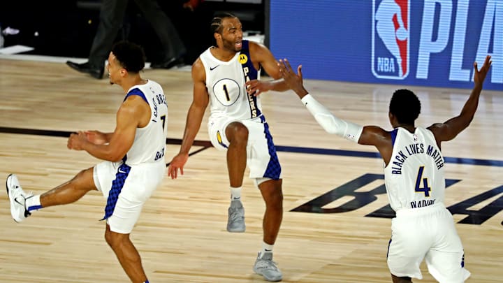 Aug 8, 2020; Lake Buena Vista, Florida, USA; Indiana Pacers forward T.J. Warren (1) celebrates with guard Malcolm Brogdon (7) and guard Victor Oladipo (4) after a play against the Los Angeles Lakers in a NBA basketball game at The Field House. Mandatory Credit: Kim Klement-Imagn Images Aug 8, 2020; Lake Buena Vista, Florida, USA; Indiana Pacers forward T.J. Warren (1) celebrates with guard Malcolm Brogdon (7) and guard Victor Oladipo (4) after a play against the Los Angeles Lakers in a NBA basketball game at The Field House. Mandatory Credit: Kim Klement-Imagn Images
