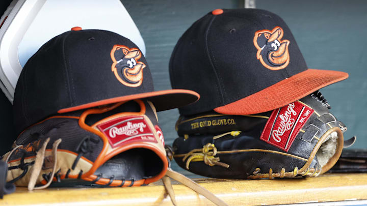 Baltimore Orioles hats and glove sits in dugout Baltimore Orioles hats and glove sits in dugout
