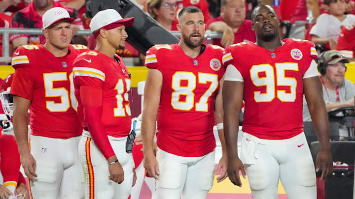 Aug 22, 2025; Kansas City, Missouri, USA; Kansas City Chiefs defensive end George Karlaftis (56) and quarterback Patrick Mahomes (15) and tight end Travis Kelce (87) and defensive tackle Chris Jones (95) watch play against the Chicago Bears during the second half of the game at GEHA Field at Arrowhead Stadium. Mandatory Credit: Denny Medley-Imagn Images