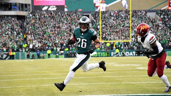 Jan 26, 2025; Philadelphia, PA, USA; Philadelphia Eagles running back Saquon Barkley (26) runs with the ball for a touchdown against the Washington Commanders during the first half in the NFC Championship game at Lincoln Financial Field. Mandatory Credit: Eric Hartline-Imagn Images