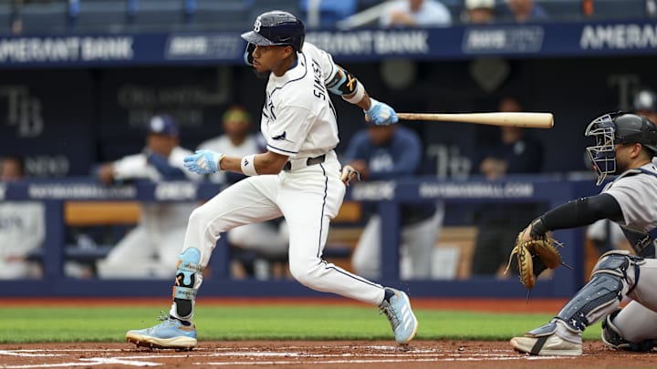 Apr 12, 2026; St. Petersburg, Florida, USA; Tampa Bay Rays left fielder Chandler Simpson (14) singles against the New York Yankees in the first inning at Tropicana Field. 