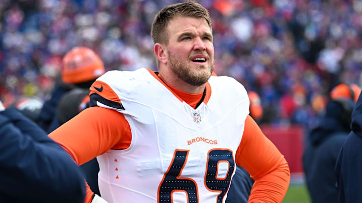 Jan 12, 2025; Orchard Park, New York, USA; Denver Broncos offensive tackle Mike McGlinchey (69) on the sidelines before an AFC wild card game against the Buffalo Bills at Highmark Stadium. 