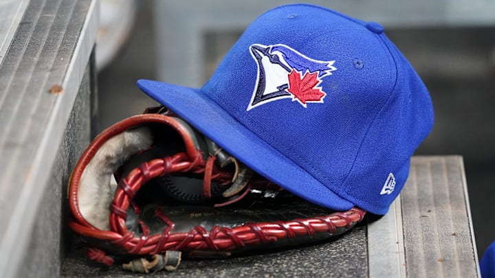 Apr 16, 2025; Toronto, Ontario, CAN; A Toronto Blue Jays hat and glove in the dugout during a game against the Atlanta Braves at Rogers Centre.