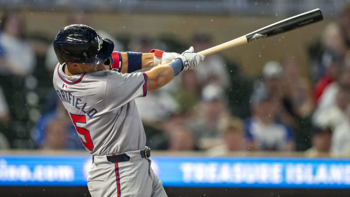 Aug 26, 2024; Minneapolis, Minnesota, USA; Atlanta Braves second baseman Whit Merrifield (15) hits a single against the Minnesota Twins in the third inning at Target Field. Mandatory Credit: Jesse Johnson-USA TODAY Sports