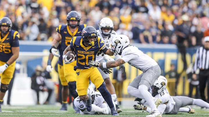 Nov 8, 2025; Morgantown, West Virginia, USA; West Virginia Mountaineers running back Diore Hubbard (20) runs the ball during the fourth quarter against the Colorado Buffaloes at Milan Puskar Stadium. Mandatory Credit: Ben Queen-Imagn Images Nov 8, 2025; Morgantown, West Virginia, USA; West Virginia Mountaineers running back Diore Hubbard (20) runs the ball during the fourth quarter against the Colorado Buffaloes at Milan Puskar Stadium. Mandatory Credit: Ben Queen-Imagn Images