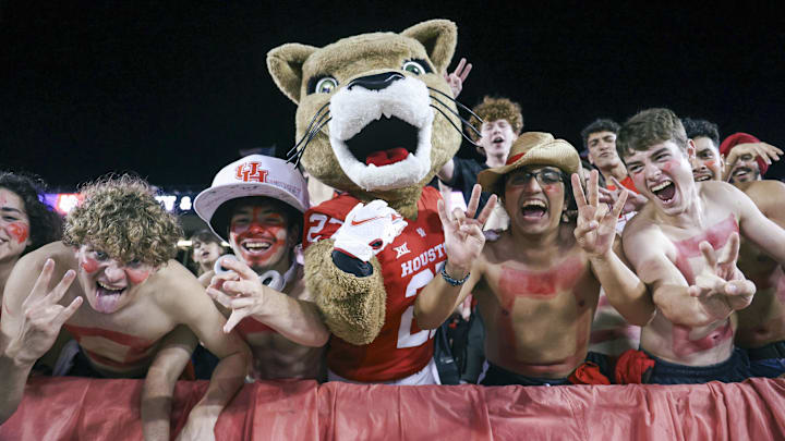 Houston Cougars mascot Shasta cheers with fans during the game against the Utah Utes