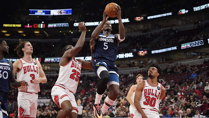 Oct 16, 2025; Chicago, Illinois, USA; Chicago Bulls forward/center Jalen Smith (25) defends Minnesota Timberwolves guard Anthony Edwards (5) during the first half at United Center.