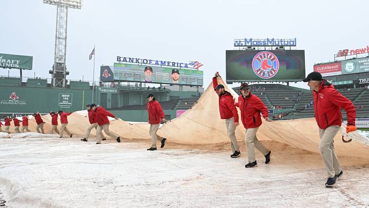 Apr 30, 2023: Grounds crew removing the tarp at Fenway Park before the game between the Cleveland Guardians and the Boston Red Sox. Credit: Brian Fluharty-USA TODAY Sports