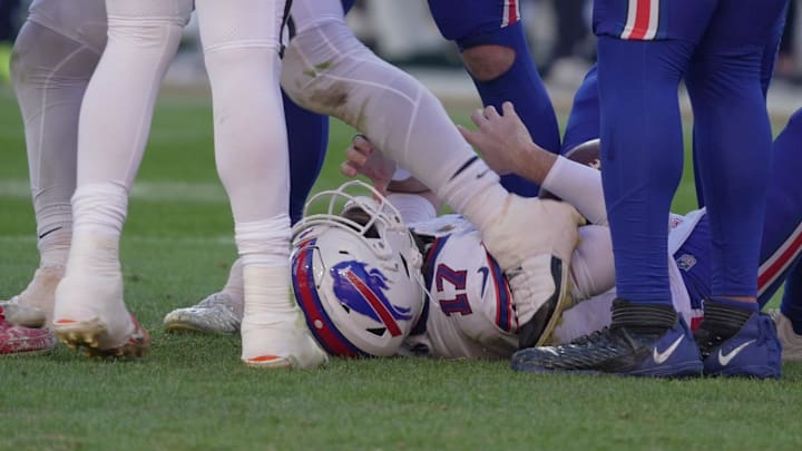 A Denver player drags his foot across Buffalo Bills quarterback Josh Allen as he gets off him after being in on the tackle during first half action on Jan. 17, 2026.