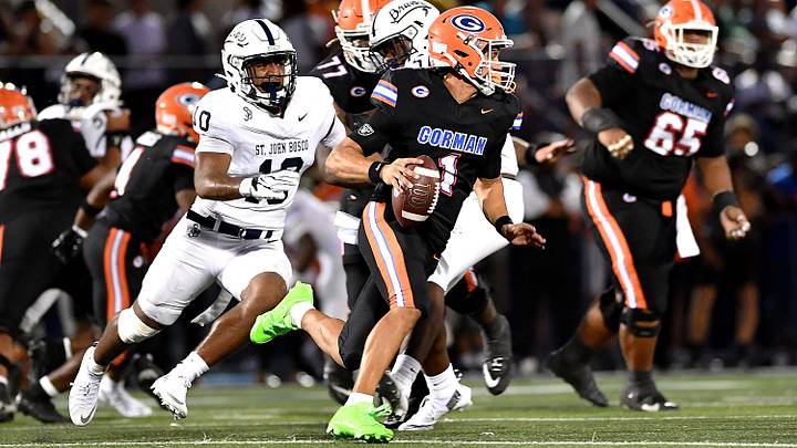 Bishop Gorman quarterback Ace Amina (1), who had four passing touchdowns, escapes the pressure of St. John Bosco's Josiah Poyer (10), during Gorman's 38-28 season-opening victory. Bishop Gorman quarterback Ace Amina (1), who had four passing touchdowns, escapes the pressure of St. John Bosco's Josiah Poyer (10), during Gorman's 38-28 season-opening victory.
