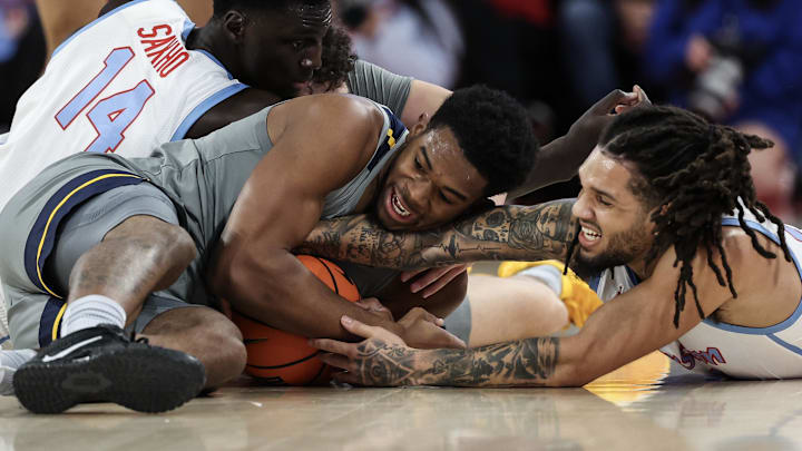 Jan 13, 2026; Houston, Texas, USA; Houston Cougars forward Joseph Tugler (11) and West Virginia Mountaineers forward DJ Thomas (5) reach for a loose ball  in the first half at Fertitta Center. Mandatory Credit: Thomas Shea-Imagn Images