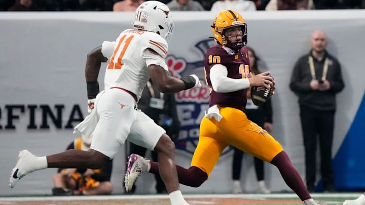 Arizona State quarterback Sam Leavitt (10) scrambles away from Texas linebacker Colin Simmons (11) during the first quarter of the Chick-fil-A Peach Bowl in Atlanta on Wednesday, Jan. 1, 2025.