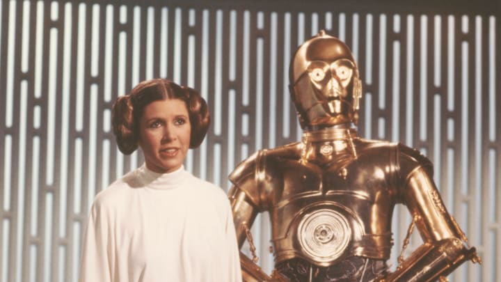 Carrie Fisher as Princess Leia and Anthony Daniels' C3PO on the set of A New Hope