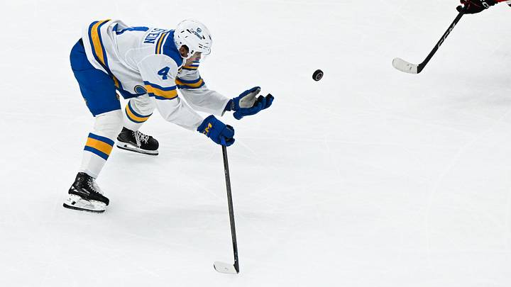 Oct 6, 2026; Chicago, Illinois, USA;  St. Louis Blues defenseman Theo Lindstein (4) flips the puck during the third period against the Chicago Blackhawks at United Center.  Mandatory Credit: Matt Marton-Imagn Images