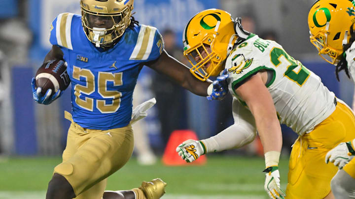 Sep 28, 2024; Pasadena, California, USA; (Editors Notes: Caption Correction) UCLA Bruins running back T.J. Harden (25) runs past Oregon Ducks linebacker Bryce Boettcher (28) during the third quarter at Rose Bowl. Mandatory Credit: Robert Hanashiro-Imagn Images Sep 28, 2024; Pasadena, California, USA; (Editors Notes: Caption Correction) UCLA Bruins running back T.J. Harden (25) runs past Oregon Ducks linebacker Bryce Boettcher (28) during the third quarter at Rose Bowl. Mandatory Credit: Robert Hanashiro-Imagn Images