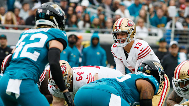 Nov 12, 2023; Jacksonville, Florida, USA; San Francisco 49ers quarterback Brock Purdy (13) calls a play guarded by offensive tackle Jake Brendel (64) and offensive tackle Jon Feliciano (55) with Jacksonville Jaguars safety Andrew Wingard (42) and defensive lineman Roy Robertson-Harris (95) lined up during the first quarter at EverBank Stadium. Mandatory Credit: Morgan Tencza-Imagn Images Nov 12, 2023; Jacksonville, Florida, USA; San Francisco 49ers quarterback Brock Purdy (13) calls a play guarded by offensive tackle Jake Brendel (64) and offensive tackle Jon Feliciano (55) with Jacksonville Jaguars safety Andrew Wingard (42) and defensive lineman Roy Robertson-Harris (95) lined up during the first quarter at EverBank Stadium. Mandatory Credit: Morgan Tencza-Imagn Images