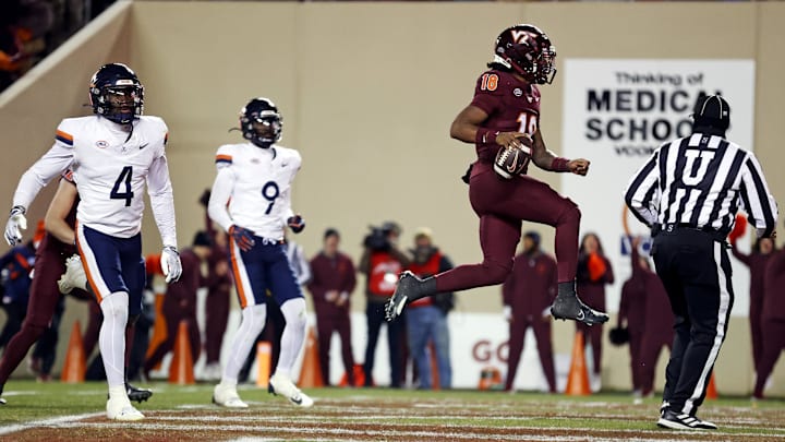 Nov 30, 2024; Blacksburg, Virginia, USA; Virginia Tech Hokies quarterback William Watson III (18) scores a touchdown during the third quarter against the Virginia Cavaliers at Lane Stadium. Mandatory Credit: Peter Casey-Imagn Images