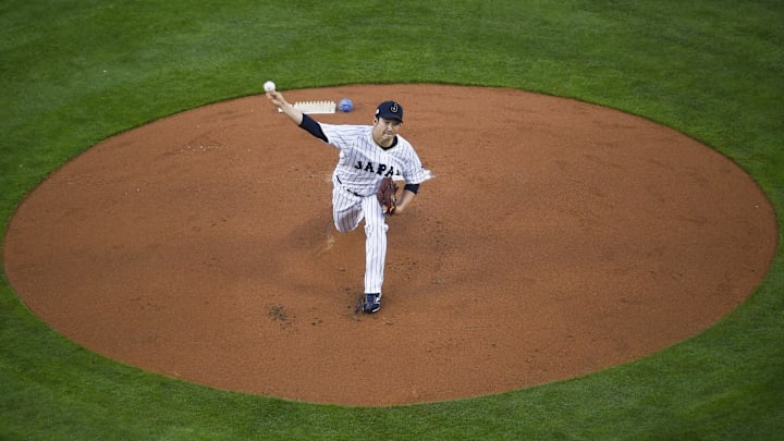 Mar 21, 2017; Los Angeles, CA, USA; Japan starting pitcher Tomoyuki Sugano (11) pitches against the United States during the first inning of the 2017 World Baseball Classic at Dodger Stadium.