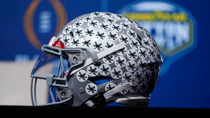 An Ohio State Buckeyes helmet sits in the desk in front of head coach Ryan Day as he talks to media during a Cotton Bowl press conference at AT&T Stadium in Arlington, Texas prior to their College Football Playoff quarterfinal matchup on Dec. 30, 2025. An Ohio State Buckeyes helmet sits in the desk in front of head coach Ryan Day as he talks to media during a Cotton Bowl press conference at AT&T Stadium in Arlington, Texas prior to their College Football Playoff quarterfinal matchup on Dec. 30, 2025.