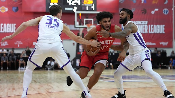 Jul 16, 2022; Las Vegas, NV, USA; Houston Rockets forward Anthony Lamb (33) drives between Sacramento Kings guard Alex O'Connell (35) and Sacramento Kings guard TJ Starks (20) during an NBA Summer League game at Cox Pavillion. Mandatory Credit: Stephen R. Sylvanie-USA TODAY Sports