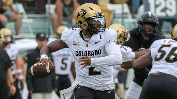 Sep 28, 2024; Orlando, Florida, USA; Colorado Buffaloes quarterback Shedeur Sanders (2) rolls out to pass against the UCF Knights during the first quarter at FBC Mortgage Stadium. Mandatory Credit: Mike Watters-Imagn Images