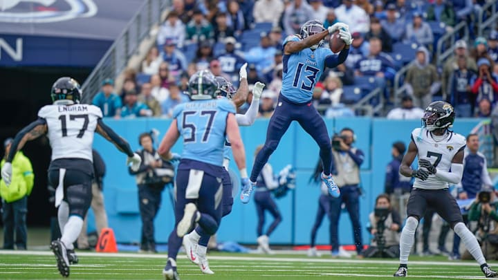 Tennessee Titans cornerback Chidobe Awuzie (13) intercepts the ball during the first quarter at Nissan Stadium in Nashville, Tenn., Sunday, Dec. 8, 2024.