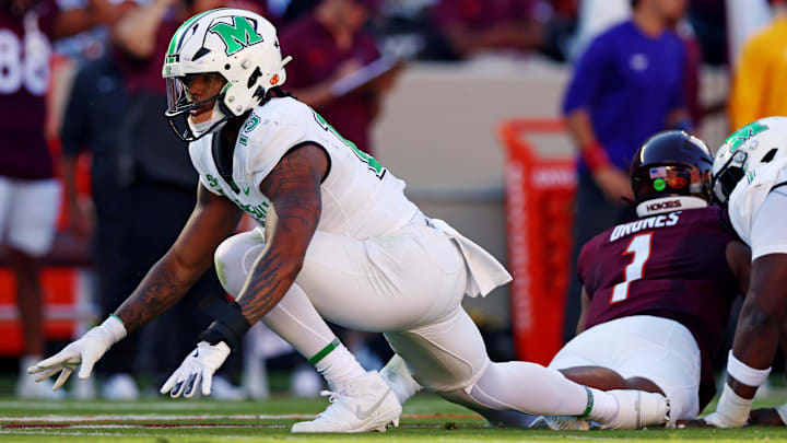 Sep 7, 2024; Blacksburg, Virginia, USA; Marshall Thundering Herd defensive lineman Mike Green (15) celebrates after sacking Virginia Tech Hokies quarterback Kyron Drones (1) during the first quarter at Lane Stadium. Mandatory Credit: Peter Casey-Imagn Images
