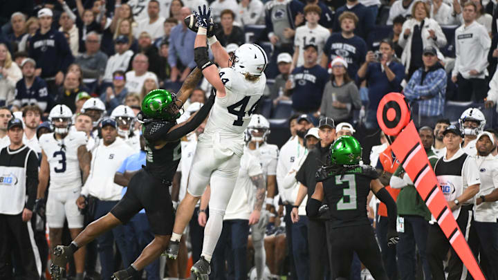 Dec 7, 2024; Indianapolis, IN, USA; Penn State Nittany Lions tight end Tyler Warren (44) catches a pass over the head of Oregon Ducks linebacker Devon Jackson (26) during the third quarter in the 2024 Big Ten Championship game at Lucas Oil Stadium. Mandatory Credit: Robert Goddin-Imagn Images