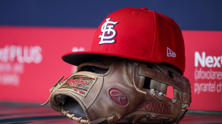 Apr 21, 2025; Atlanta, Georgia, USA; A St. Louis Cardinals hat and glove in the dugout against the Atlanta Braves in the first inning at Truist Park. Mandatory Credit: Brett Davis-Imagn Images