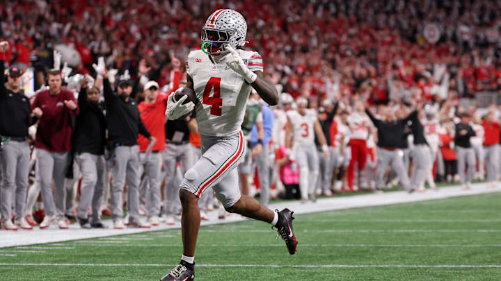 Jan 20, 2025; Atlanta, GA, USA; Ohio State Buckeyes wide receiver Jeremiah Smith (4) runs with the ball for a touchdown during the first half the CFP National Championship college football game at Mercedes-Benz Stadium. Mandatory Credit: Brett Davis-Imagn Images Jan 20, 2025; Atlanta, GA, USA; Ohio State Buckeyes wide receiver Jeremiah Smith (4) runs with the ball for a touchdown during the first half the CFP National Championship college football game at Mercedes-Benz Stadium. Mandatory Credit: Brett Davis-Imagn Images