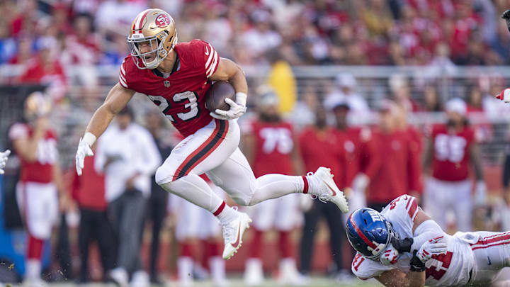 September 21, 2023; Santa Clara, California, USA; San Francisco 49ers running back Christian McCaffrey (23) runs past New York Giants linebacker Micah McFadden (41) during the second quarter at Levi's Stadium. September 21, 2023; Santa Clara, California, USA; San Francisco 49ers running back Christian McCaffrey (23) runs past New York Giants linebacker Micah McFadden (41) during the second quarter at Levi's Stadium.