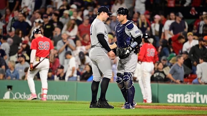 Sep 14, 2023; Boston, Massachusetts, USA; New York Yankees relief pitcher Tommy Kahnle (41) and catcher Kyle Higashioka (66) celebrate defeating the Boston Red Sox at Fenway Park. Mandatory Credit: Eric Canha-Imagn Images