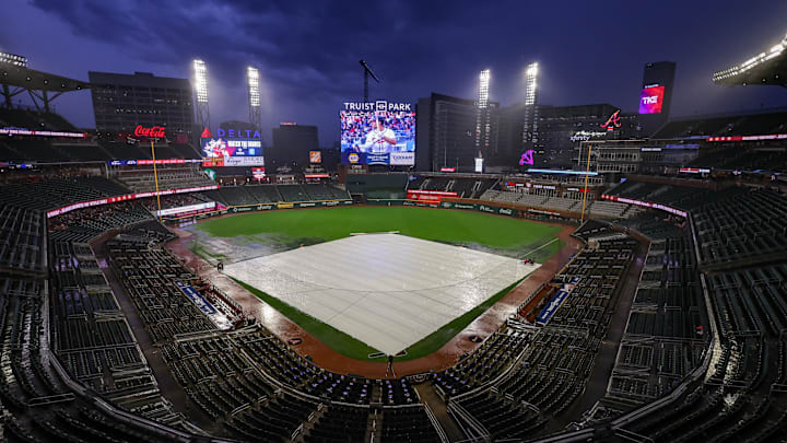 Jun 27, 2025; Atlanta, Georgia, USA; The tarp covers the field during a rain delay before a game between the Atlanta Braves and Philadelphia Phillies at Truist Park. Mandatory Credit: Brett Davis-Imagn Images