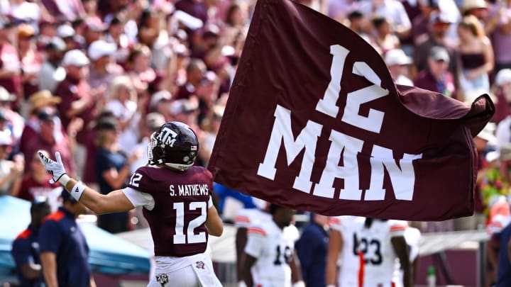 Sep 23, 2023; College Station, Texas, USA; Texas A&M Aggies linebacker Sam Mathews (12) waves the 12th Man flag during pre-game runout against the Auburn Tigers at Kyle Field. Mandatory Credit: Maria Lysaker-USA TODAY Sports Sep 23, 2023; College Station, Texas, USA; Texas A&M Aggies linebacker Sam Mathews (12) waves the 12th Man flag during pre-game runout against the Auburn Tigers at Kyle Field. Mandatory Credit: Maria Lysaker-USA TODAY Sports