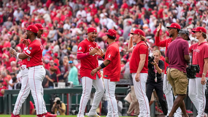 The Cincinnati Reds celebrate a win after the ninth inning of the MLB National League game between the Cincinnati Reds and the Pittsburgh Pirates at Great American Ball Park in downtown Cincinnati on Thursday, Sept. 25, 2025. The Reds won, 2-1.