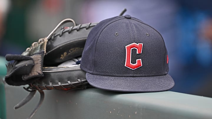 Jun 27, 2024; Kansas City, Missouri, USA; A general view a Cleveland Guardians hat and glove on the dugout railing before a game against the Kansas City Royals at Kauffman Stadium. Mandatory Credit: Peter Aiken-Imagn Images Jun 27, 2024; Kansas City, Missouri, USA; A general view a Cleveland Guardians hat and glove on the dugout railing before a game against the Kansas City Royals at Kauffman Stadium. Mandatory Credit: Peter Aiken-Imagn Images