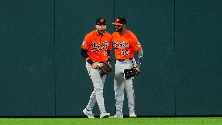 Aug 31, 2026: Baltimore Orioles center fielder Colton Cowser (17) reacts with right fielder Leody Taveras (30) after making a catch at the fence in the ninth inning against the Colorado Rockies at Coors Field. Credit: Isaiah J. Downing-Imagn Images