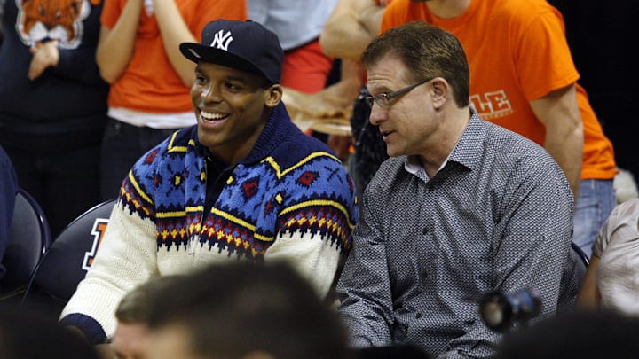 Feb 6, 2013; Auburn, AL, USA: Carolina Panthers quarterback Cam Newton and Auburn Tigers head football coach Gus Malzahn talk during the game against the Alabama Crimson Tide at Auburn Arena.  The Tigers beat the Tide 49-37.  Mandatory Credit: John Reed-USA TODAY Sports