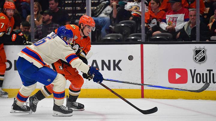 Oct 7, 2026; Anaheim, California, USA; Anaheim Ducks left wing Jeff Malott (39) plays for the puck against Edmonton Oilers defenseman Ryan Shea (6) during the first period at Honda Center. Mandatory Credit: Gary A. Vasquez-Imagn Images