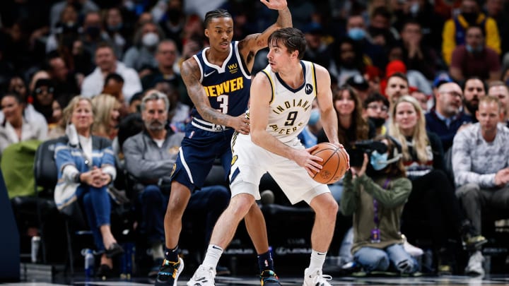 Nov 10, 2021; Denver, Colorado, USA; Indiana Pacers guard T.J. McConnell (9) controls the ball under pressure from Denver Nuggets guard Bones Hyland (3) in the fourth quarter at Ball Arena. Mandatory Credit: Isaiah J. Downing-USA TODAY Sports