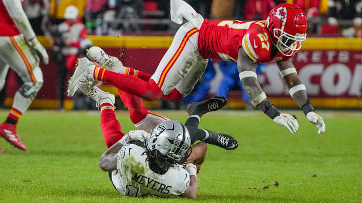 Nov 29, 2024; Kansas City, Missouri, USA; Kansas City Chiefs safety Chamarri Conner (27) leaps over as Las Vegas Raiders wide receiver Jakobi Meyers (16) is tackled during the second half at GEHA Field at Arrowhead Stadium. Mandatory Credit: Denny Medley-Imagn Images