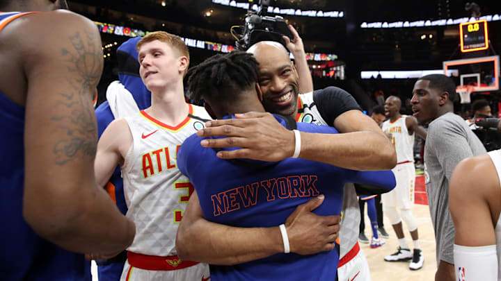 Mar 11, 2020; Atlanta, Georgia, USA; Atlanta Hawks guard Vince Carter (facing camera) hugs a New York Knicks player after the Knicks overtime victory over the Hawks at State Farm Arena. Mandatory Credit: Jason Getz-Imagn Images