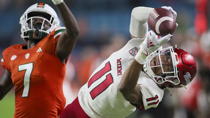 Sep 1, 2023; Miami Gardens, Florida, USA; Miami Redhawks wide receiver Javon Tracy (11) catches the football but lands out of bounds ahead of Miami Hurricanes defensive back Davonte Brown (7) during the fourth quarter at Hard Rock Stadium. Mandatory Credit: Sam Navarro-Imagn Images Sep 1, 2023; Miami Gardens, Florida, USA; Miami Redhawks wide receiver Javon Tracy (11) catches the football but lands out of bounds ahead of Miami Hurricanes defensive back Davonte Brown (7) during the fourth quarter at Hard Rock Stadium. Mandatory Credit: Sam Navarro-Imagn Images