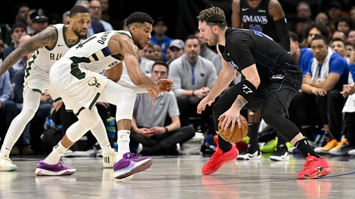Feb 3, 2024; Dallas, Texas, USA; Dallas Mavericks guard Luka Doncic (77) looks to move the ball past Milwaukee Bucks guard Damian Lillard (0) and forward Giannis Antetokounmpo (34) during the second half at the American Airlines Center. Mandatory Credit: Jerome Miron-Imagn Images Feb 3, 2024; Dallas, Texas, USA; Dallas Mavericks guard Luka Doncic (77) looks to move the ball past Milwaukee Bucks guard Damian Lillard (0) and forward Giannis Antetokounmpo (34) during the second half at the American Airlines Center. Mandatory Credit: Jerome Miron-Imagn Images