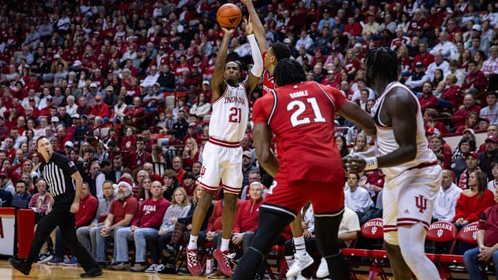 Indiana Hoosiers forward Mackenzie Mgbako (21) shoots the ball while Rutgers Scarlet Knights center Emmanuel Ogbole (21) defends in the first half at Simon Skjodt Assembly Hall. Indiana Hoosiers forward Mackenzie Mgbako (21) shoots the ball while Rutgers Scarlet Knights center Emmanuel Ogbole (21) defends in the first half at Simon Skjodt Assembly Hall.