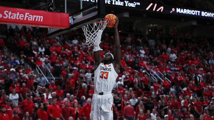 Mar 4, 2023; Lubbock, Texas, USA;  Oklahoma State Cowboys forward Moussa Cisse (33) slam dunks the