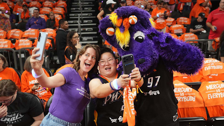 Fans take photos with Scorch the Phoenix Mercury mascot before their WNBA Finals game against the Las Vegas Aces at the Mortgage Matchup Center in Phoenix on Oct. 8, 2025. Fans take photos with Scorch the Phoenix Mercury mascot before their WNBA Finals game against the Las Vegas Aces at the Mortgage Matchup Center in Phoenix on Oct. 8, 2025.